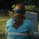 Sadie Sink as Max in Stranger Things in front of a tombstone